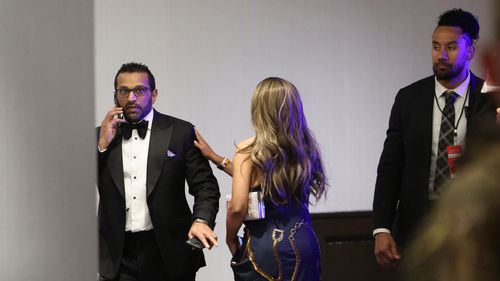 FBI director Kash Patel talks on the phone during the White House Correspondents Dinner, Saturday, April 25, 2026, in Washington. (AP Photo/Tom Brenner)