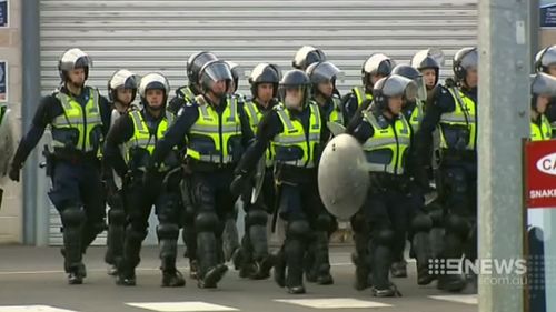 Riot police move in. (9NEWS)