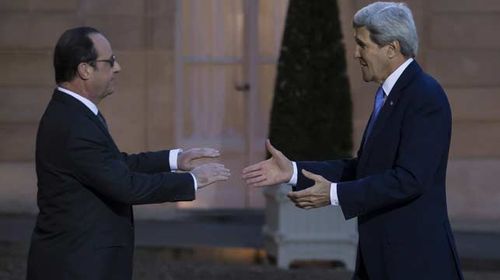 US Secretary of State John Kerry embraces French president Francois Hollande ahead of a meeting at the Elysee Palace in Paris. (AAP)
