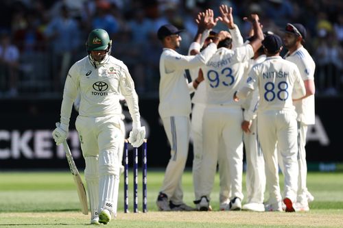 Usman Khawaja walks off the field after being dismissed by Jasprit Bumrah during the first Test.