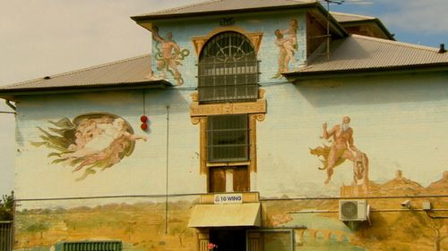 Coloured murals break up the monotony of the jail's brick walls.