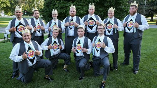 The groom and his groomsmen in their Burger King shirts. (Getty)