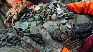 Treasure hunters have salvaged a British ship that was sunk during World War II carrying tonnes of silver coins estimated to be worth millions of dollars. 