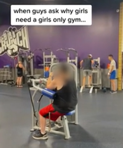 Man at gym filming on phone
