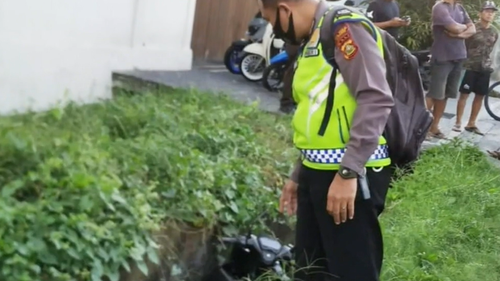 Police inspect the crash site following the discovery of Keith Coughlan's body. 