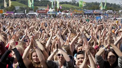 The crowd at Glastonbury Music Festival clap their hands above their heads as they watch Chipmunk on stage, on June 24, 2011 in Glastonbury, England