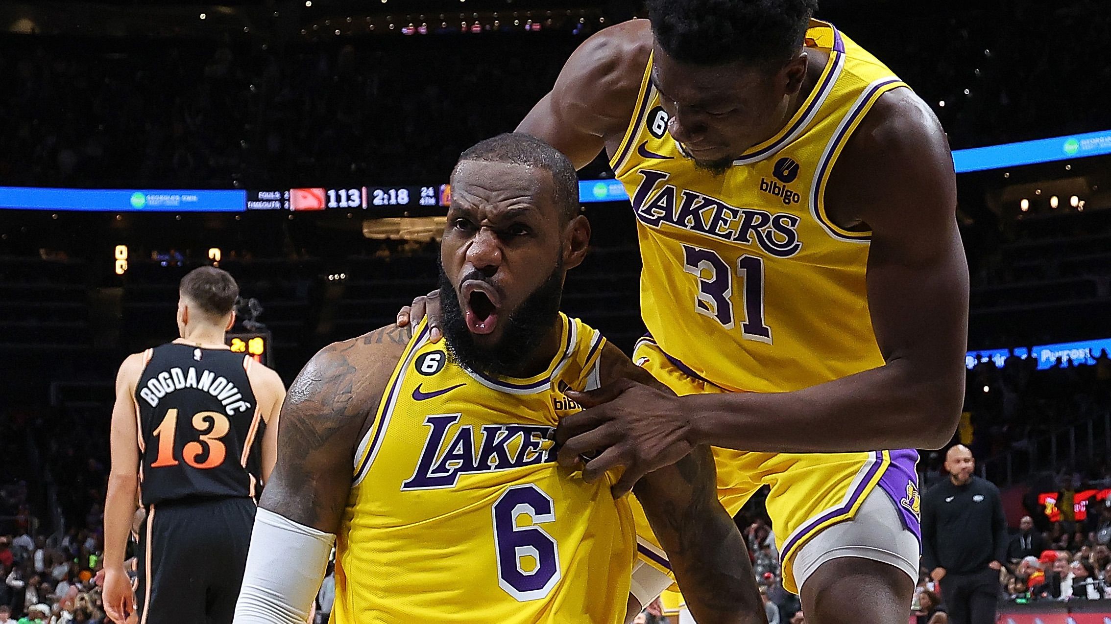 LeBron James #6 of the Los Angeles Lakers reacts with Thomas Bryant #31 after drawing a foul on a basket against the Atlanta Hawks during the fourth quarter at State Farm Arena on December 30, 2022 in Atlanta, Georgia. (Photo by Kevin C. Cox/Getty Images)