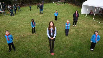 Duchess of Cambridge poses for a photograph with members of the Beaver Scouts during her visit to a Scout Group in Northolt, northwest London where she joined Cub and Beaver Scouts in outdoor activities on September 29, 2020 in London, England.