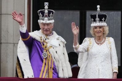 King Charles III and Queen Camilla wave to the crowds from the balcony of Buckingham Palace after the coronation ceremony in London, Saturday, May 6, 2023. 
