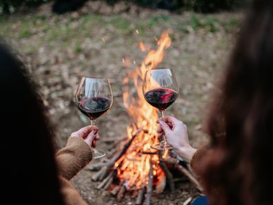 Mums sharing a wine or several while camping