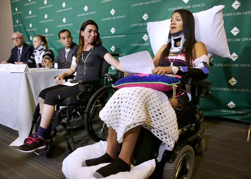 Circus acrobat Julissa Segrera, second from right, from the United States, and Dayana Costa, right, from Brazil, cry as Ms. Costa reads a statement at the Spaulding Rehabilitation Hospital in Boston.  They were among eight acrobats injured when the apparatus from which they were suspended fell, sending them to the ground during a performance.