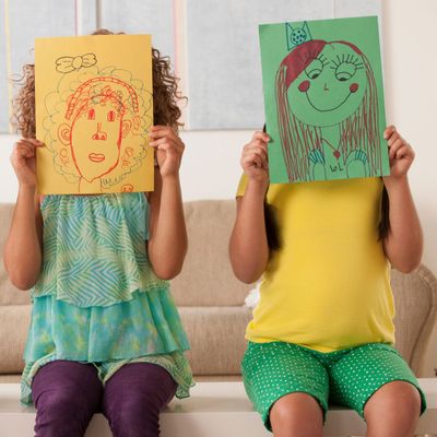Children holding up drawings&nbsp;