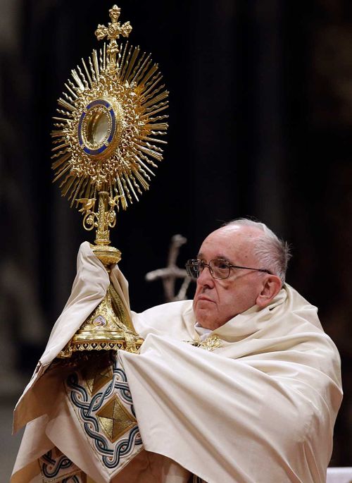 Pope Francis holds a monstrance as he celebrates a New Year's Eve vespers Mass in St. Peter's Basilica at the Vatican. (AAP)