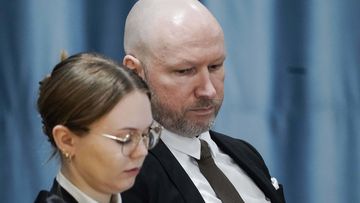 Anders Behring Breivik and attorney Marte Lindholm sits, as the Oslo district court conducts his case in a gymnasium at Ringerike prison, in Ringerike, Norway.