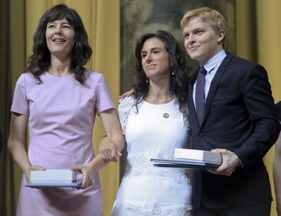 Megan Twohey, left, Jodi Kantor, centre, and Ronan Farrow accept their 2018 Pulitzer Prize awards.