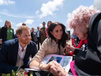 Prince Harry, Duke of Sussex and Meghan, Duchess of Sussex greet Daphne Dunne at the Sydney Opera House on October 16, 2018.