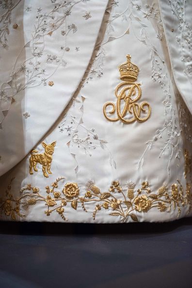 A close-up of embroidered details on The Queen's Coronation Dress, including one of Her Majesty's Jack Russell Terriers and the name of one of her grandchildren.