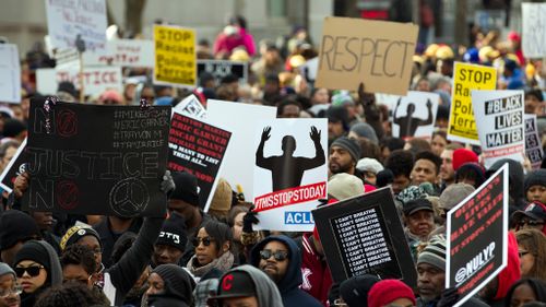 Demonstrators march on Pennsylvania Avenue toward Capitol Hill in Washington. (AAP)