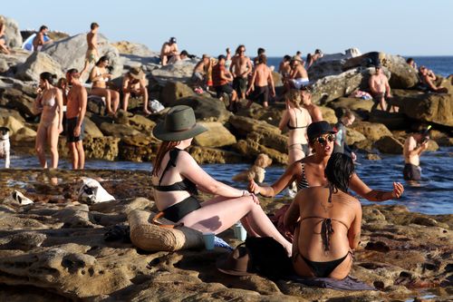 Beachgoers are seen at Bondi Beach despite the threat of Coronavirus (COVID-19) in Sydney, Friday, March 20, 2020.