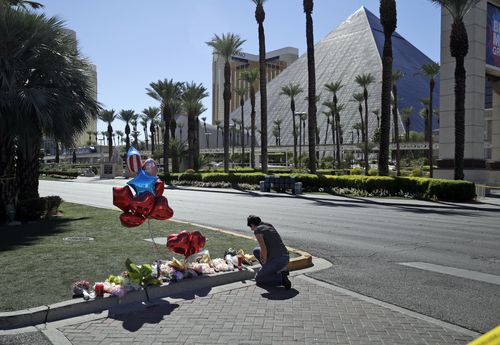 A woman pauses at a memorial on the Strip. (AAP)