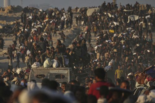 Palestinians carry sacks of flour unloaded from a humanitarian aid convoy that reached Gaza City from the northern Gaza Strip.