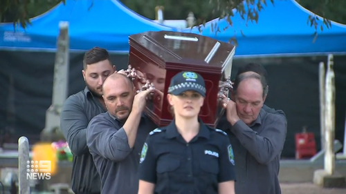 Adelaide Cemetery Authority pall bearers carry the body of the exhumed Somerton man.
