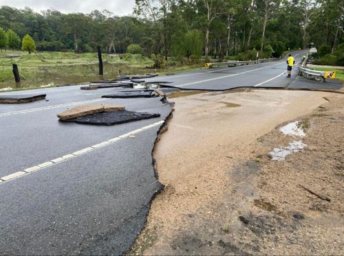 Floodwaters caused a portion of the road in north-west Sydney to wash away. 