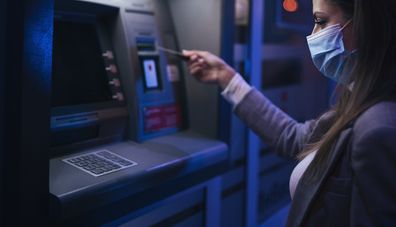 Woman using ATM