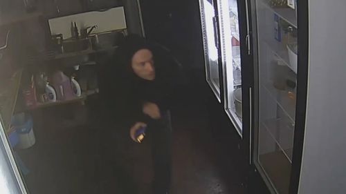 CCTV shows the man breaking into the restaurant with a hoodie stretched over his head. (Victoria Police)