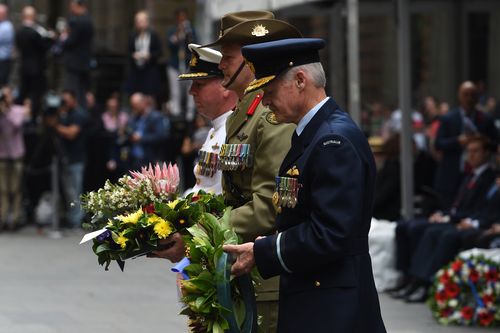 Representatives of the Australian Defence Forces prepare to lay wreaths during the Remembrance Day service at the Cenotaph in Sydney. (AAP)