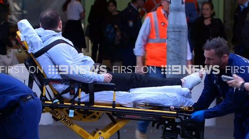 Two people have been hurt after a metal panel was torn off a building at a railway station in Sydney's CBD. (9NEWS)