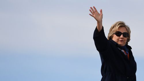 US Democratic presidential nominee Hillary Clinton waves as she boards her campaign plane at the Westchester County Airport in White Plains, New York, on October 29, 2016. (AFP)