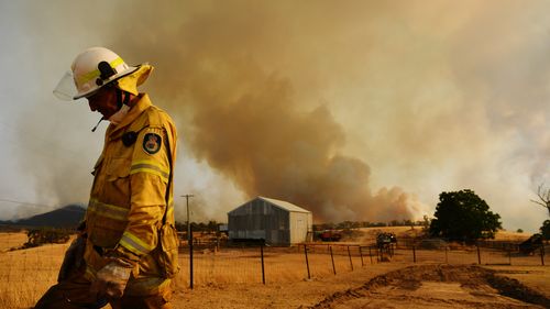 TUMURUMBA, AUSTRALIA - JANUARY 11: A Rural Fire Service firefighter Trevor Stewart views a flank of a fire on January 11, 2020 in Tumburumba, Australia. Cooler temperatures forecast for the next seven days will bring some reprieve to firefighters in NSW following weeks of emergency level bushfires across the state, with crews to use the more favourable conditions to contain fires currently burning. 20 people have died in the bushfires across Australia in recent weeks, including three volunteer f