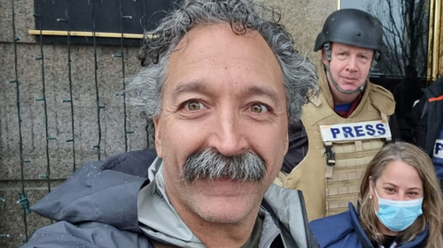 This image released by Fox News Channel shows cameraman Pierre Zakrzewski while on assignment with colleagues, Fox News correspondent Steve Harrigan and Jerusalem-based senior producer Yonat Friling, background right, in Kyiv. Zakrzewski was killed in Ukraine on Monday, March 14, 2022, when the vehicle he was traveling in was struck by incoming fire. Zakrzewski was a veteran war photographer who had covered conflicts in Iraq, Afghanistan and Syria for Fox.  (Pierre Zakrzewski/Fox News via AP)