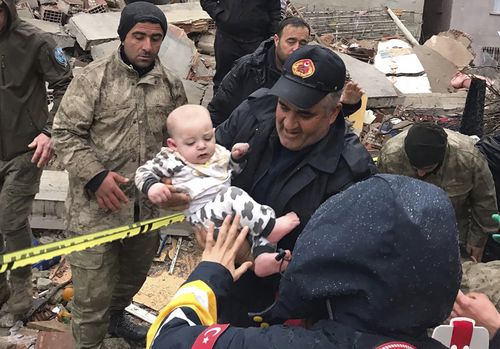 A baby is rescued from a destroyed building in Malatya, Turkey, Monday, Feb. 6, 2023. 
