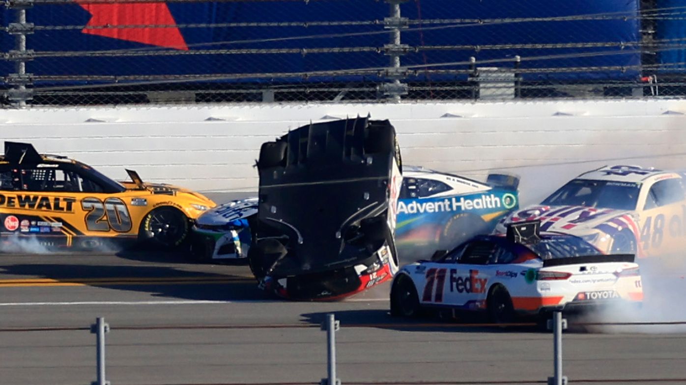 Harrison Burton, driver of the #21 Motorcraft/DEX Imaging Ford, flips after an on-track incident with Denny Hamlin, driver of the #11 FedEx Express Toyota, Ross Chastain, driver of the #1 Advent Health Chevrolet, and Kyle Busch, driver of the #18 M&amp;M&#x27;s Toyota, during the NASCAR Cup Series 64th Annual Daytona 500 at Daytona International Speedway