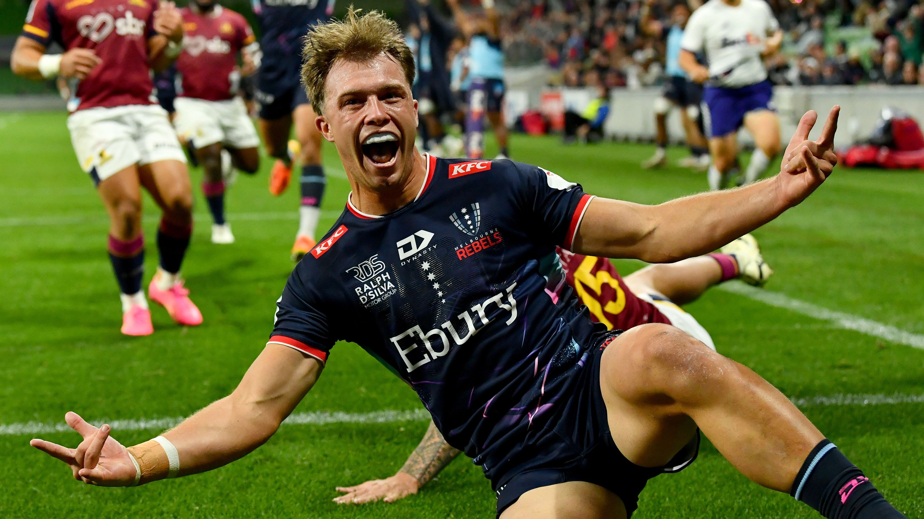 Darby Lancaster of the Rebels celebrates scoring a try.