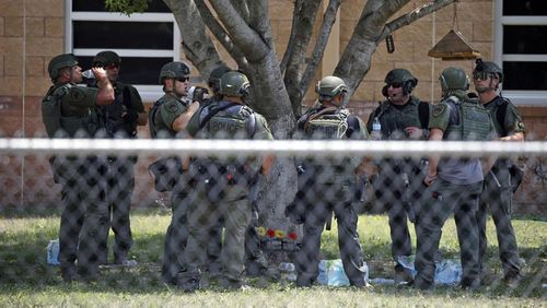  Law enforcement personnel stand outside Robb Elementary School following a shooting, May 24, 2022, in Uvalde, Texas. 