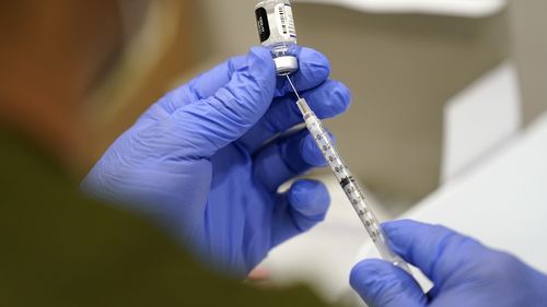 FILE - A healthcare worker fills a syringe with the Pfizer COVID-19 vaccine at Jackson Memorial Hospital on Oct. 5, 2021, in Miami. (AP Photo/Lynne Sladky, File)