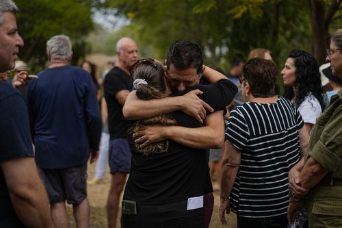 Friends and relatives of Roi Popplewell mourn during his funeral at Kibbutz Yagur near Haifa, northern Israel, Friday, Oct. 27, 2023. 