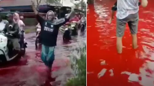 An Indonesian village has been inundated by blood-red water after flooding hit a local batik factory.