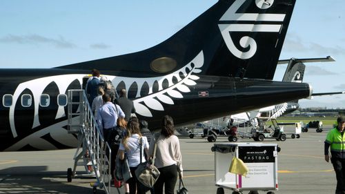 Passengers board an Air New Zealand flight at Christchurch Airport in Christchurch, New Zealand