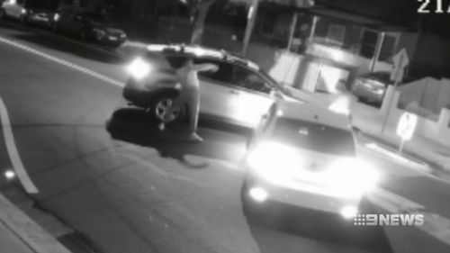 The men get out and one is shown trying to get into the other car, banging on a passenger window.