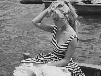 Brigitte Bardot, in a striped dress, in the 1950s. 