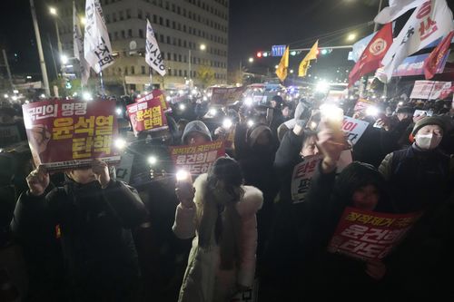 People gather to demand that South Korean President Yoon Suk Yeol step down outside the National Assembly in Seoul, South Korea, Wednesday, Dec. 4, 2024. (AP Photo/Ahn Young-joon)