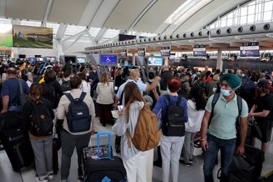 MISSISSAUGA, ON - JUNE 30: Travelers wearing face masks wait to check-in at Toronto Pearson International Airport on June 30, 2022 in Mississauga, Ontario. (Photo by Yu Ruidong/China News Service via Getty Images)