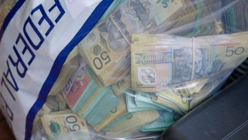 Police seized more than $1.5 million worth of cash hidden inside one Canberra home.