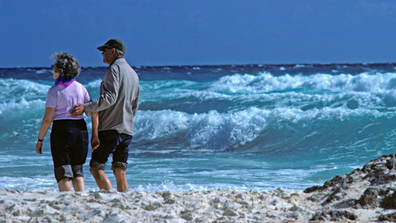 Couple walking on beach retirement 