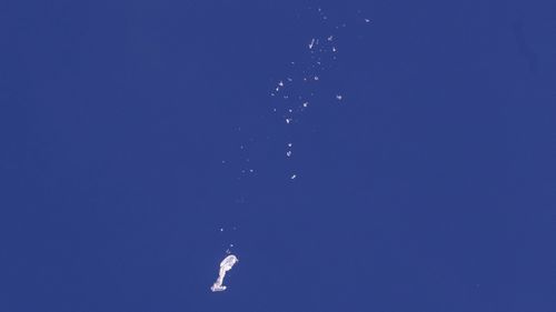 In this photo provided by Chad Fish, the remnants of a large balloon drift above the Atlantic Ocean, just off the coast of South Carolina.