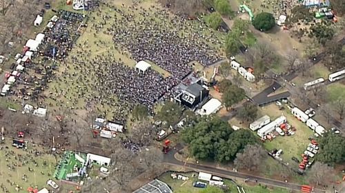 Crowds are steadily building at Yarra Park, where a Footy Festival will be held after the parade. 